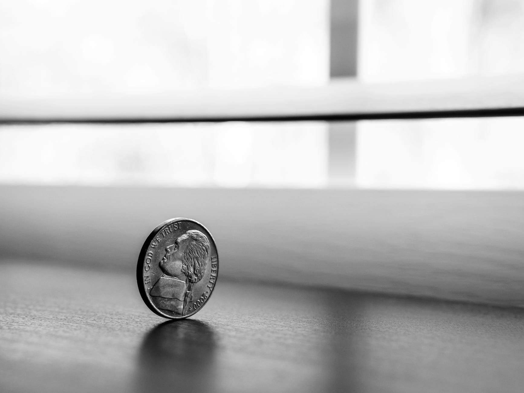 monochrome photography of round silver coin